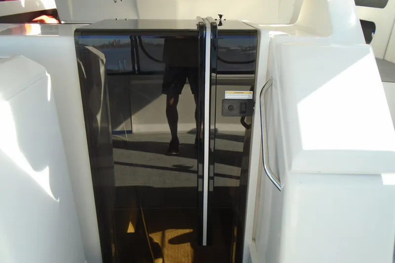 Slide: The Image of 2004 Carver 356 Motor Yacht entrance with sleek black door and chrome handle. - 10