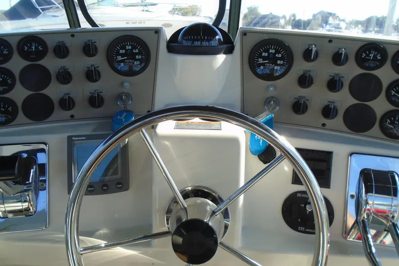 Slide: The Image of 2004 Carver 356 Motor Yacht helm with gauges, controls, and steering wheel. - 14