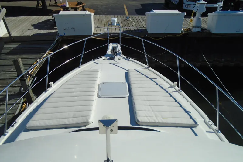 Slide: The Image of 2004 Carver 356 Motor Yacht bow with cushioned seating at dock. - 17