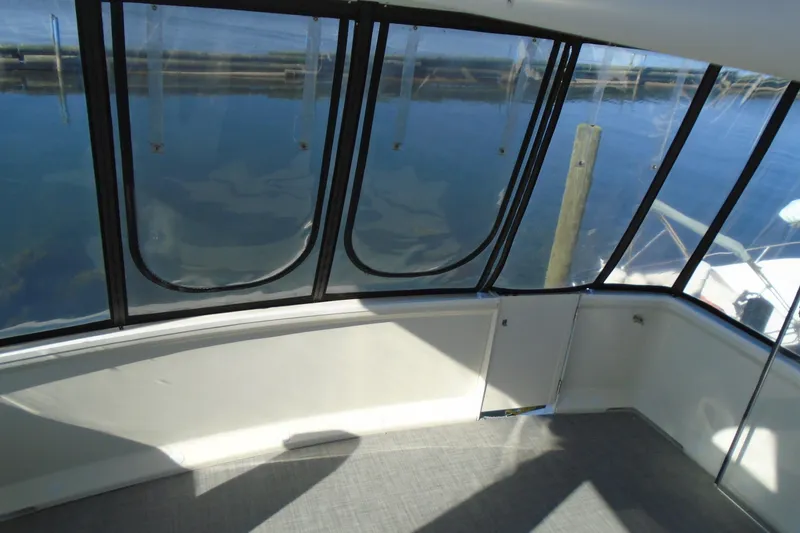 Slide: The Image of 2004 Carver 356 Motor Yacht interior with large windows and marina view. - 18