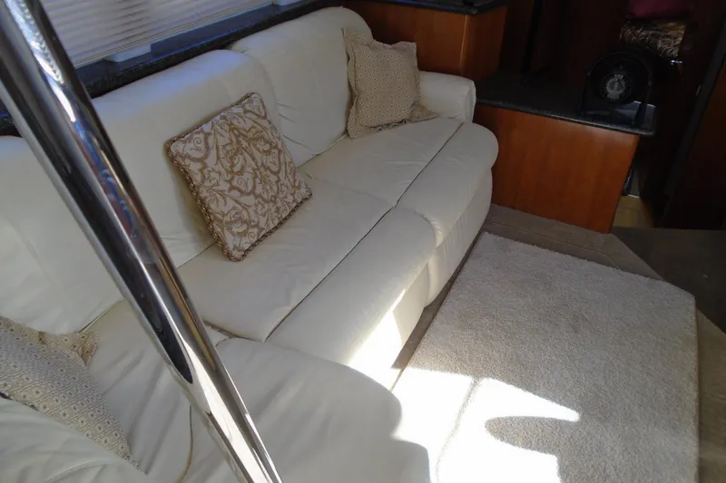 Slide: The Image of Luxurious interior of 2004 Carver 356 Motor Yacht with cream sofa and decorative pillows. - 21