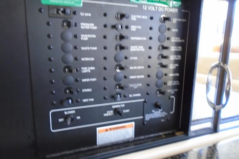 Slide: The Image of Control panel of a 2004 Carver 356 Motor Yacht, featuring 12-volt DC power switches. - 29