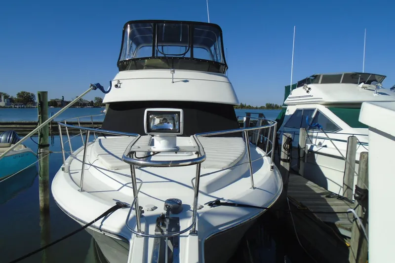 Slide: The Image of 2004 Carver 356 Motor Yacht docked at marina under clear blue sky. - 3