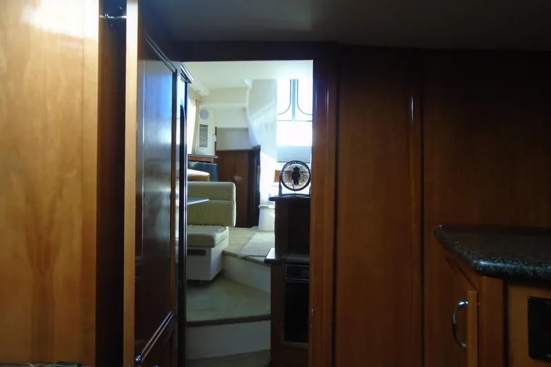 Slide: The Image of Interior view of 2004 Carver 356 Motor Yacht with wood paneling and seating area. - 37