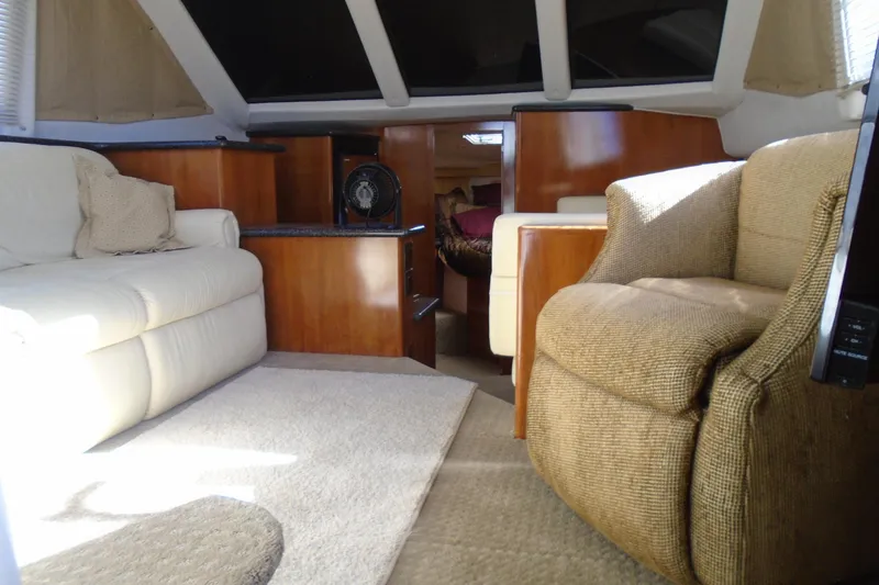 Slide: The Image of Interior of 2004 Carver 356 Motor Yacht with cozy seating and elegant wood finishes. - 49