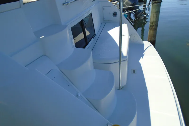 Slide: The Image of 2004 Carver 356 Motor Yacht deck with steps and railing, docked by water. - 5