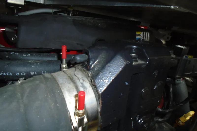 Slide: The Image of Engine compartment of a 2004 Carver 356 Motor Yacht, featuring hoses and mechanical components. - 54