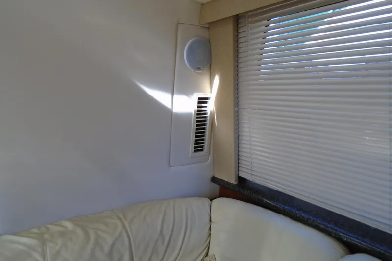 Slide: The Image of Interior of 2004 Carver 356 Motor Yacht with sofa, blinds, and speaker. - 56