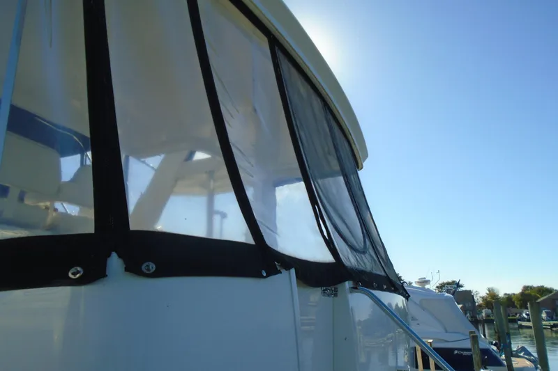 Slide: The Image of 2004 Carver 356 Motor Yacht with sunlit windows and clear blue sky. - 6