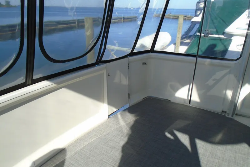 Slide: The Image of 2004 Carver 356 Motor Yacht interior with waterfront view through windows. - 8