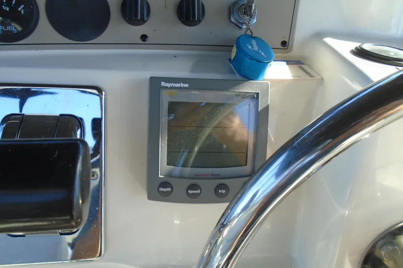 Slide: The Image of Control panel of 2004 Carver 356 Motor Yacht with Raymarine display and steering wheel. - 15