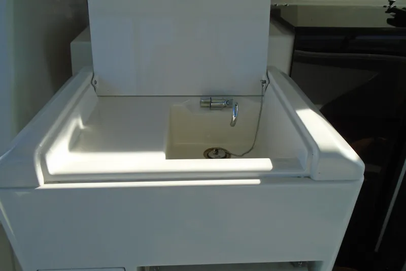 Slide: The Image of White sink on 2004 Carver 356 Motor Yacht, featuring a chrome faucet. - 19
