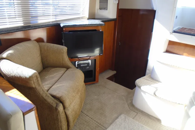 Slide: The Image of Interior of 2004 Carver 356 Motor Yacht with cozy seating and entertainment area. - 22