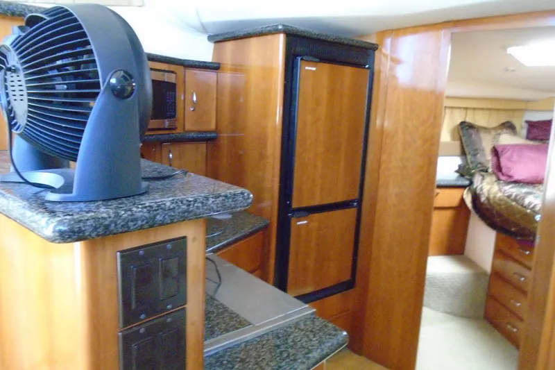 Slide: The Image of Interior of 2004 Carver 356 Motor Yacht with kitchen and bedroom view. - 25