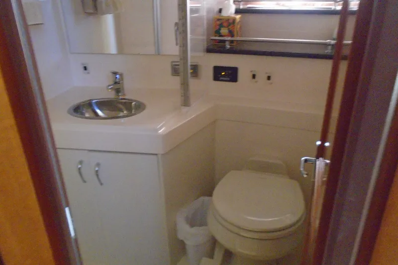 Slide: The Image of 2004 Carver 356 Motor Yacht bathroom with sink, toilet, and mirror. - 32