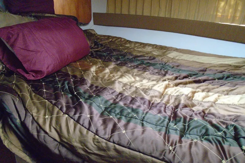 Slide: The Image of Luxurious bed inside 2004 Carver 356 Motor Yacht with elegant bedding. - 34