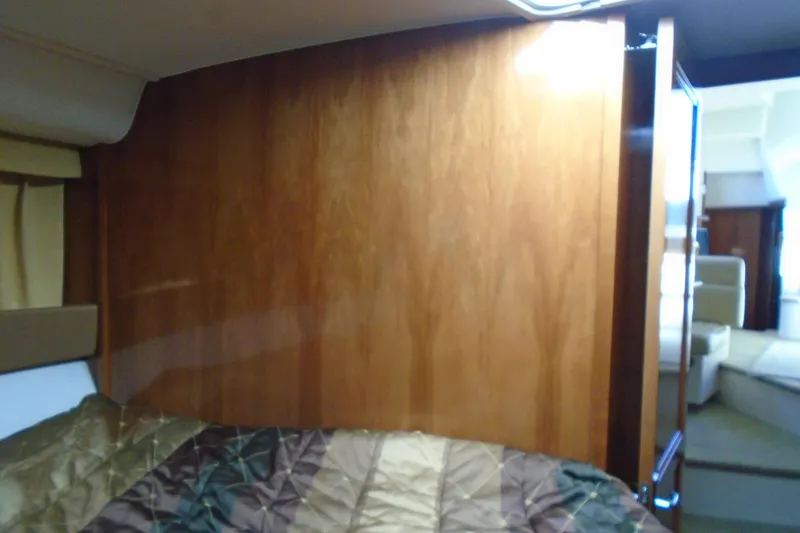 Slide: The Image of Interior cabin of 2004 Carver 356 Motor Yacht with wood paneling and bed. - 36