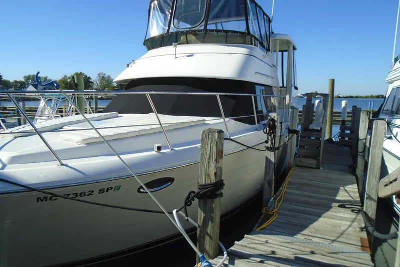 Slide: The Image of 2004 Carver 356 Motor Yacht docked at a marina under clear blue skies. - 4