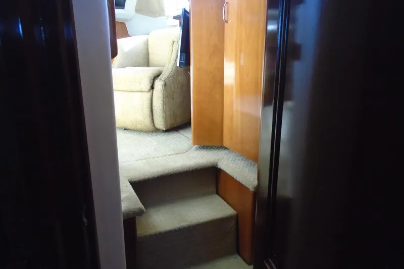 Slide: The Image of Interior of 2004 Carver 356 Motor Yacht with carpeted steps and wooden cabinetry. - 48
