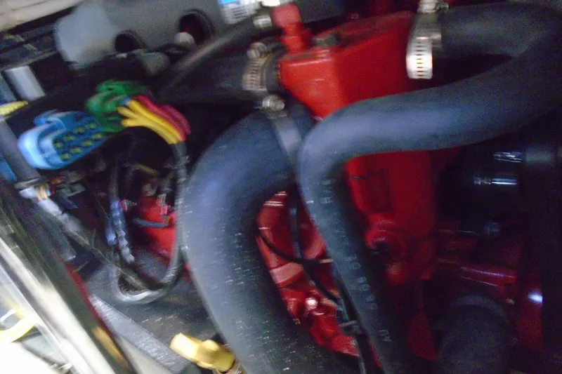 Slide: The Image of Engine compartment of a 2004 Carver 356 Motor Yacht with visible hoses and wiring. - 52
