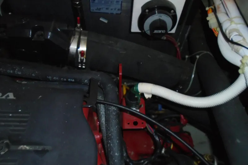 Slide: The Image of Engine compartment of a 2004 Carver 356 Motor Yacht, showing hoses and mechanical components. - 67