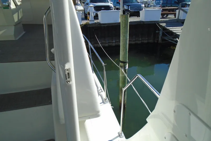 Slide: The Image of 2004 Carver 356 Motor Yacht docked at marina, showing railing and water view. - 7