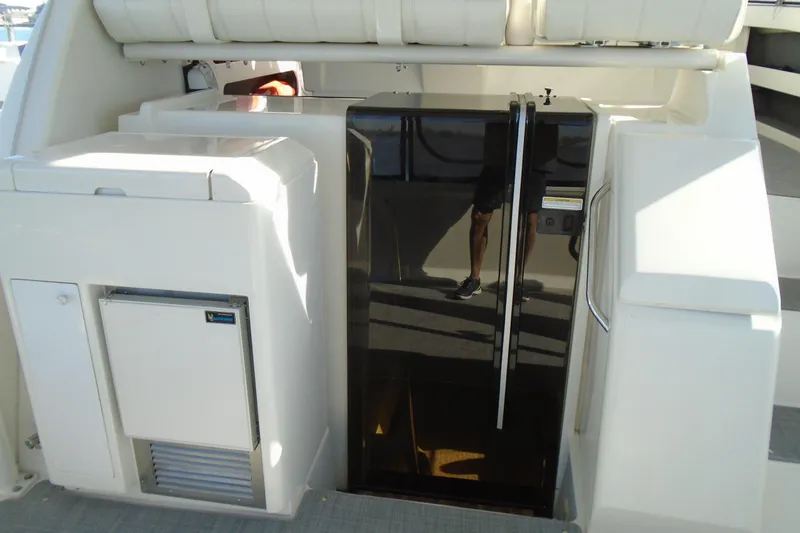 Slide: The Image of 2004 Carver 356 Motor Yacht interior with fridge and storage compartments. - 9
