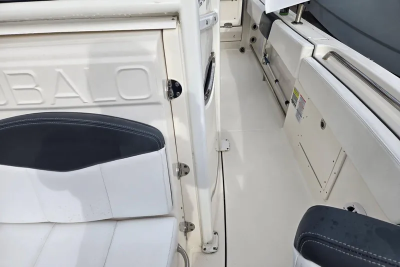 Slide: The Image of 2021 Robalo R242 Center Console boat interior with seating and storage compartments. - 28