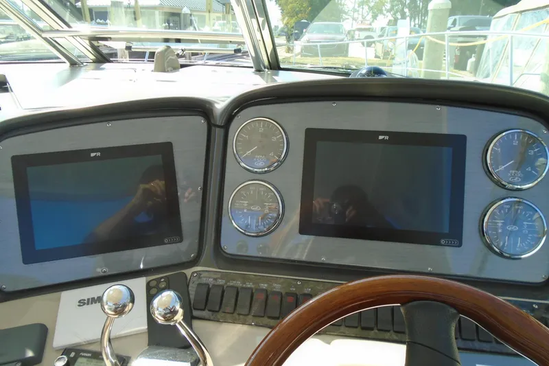 Slide: The Image of 2007 Sea Ray 40 Sundancer helm with dual screens and gauges. - 14