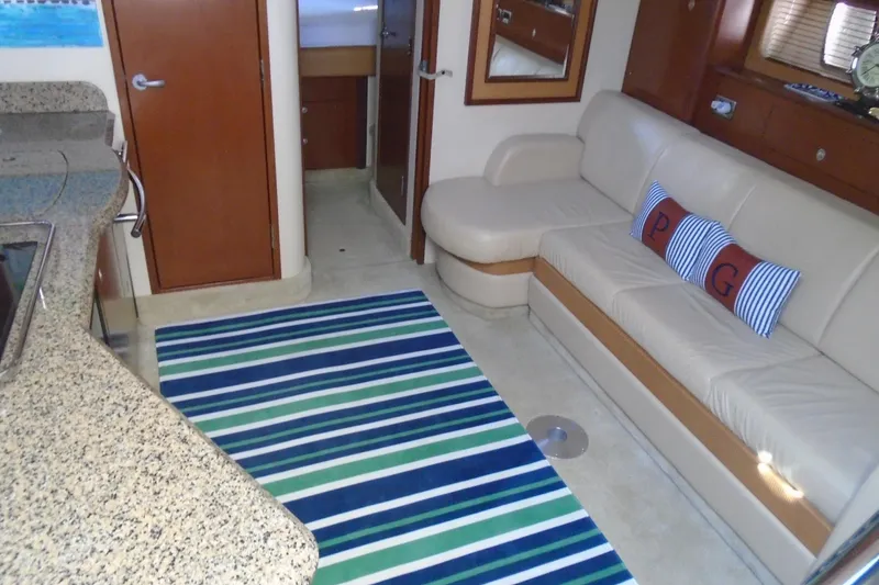 Slide: The Image of Luxurious interior of 2007 Sea Ray 40 Sundancer with striped rug and beige seating. - 21