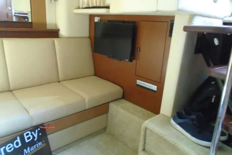 Slide: The Image of Interior of 2007 Sea Ray 40 Sundancer with beige seating and wall-mounted TV. - 26