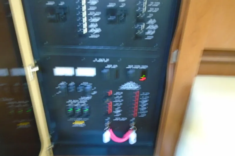 Slide: The Image of Electrical panel of a 2007 Sea Ray 40 Sundancer boat, featuring various switches and controls. - 27