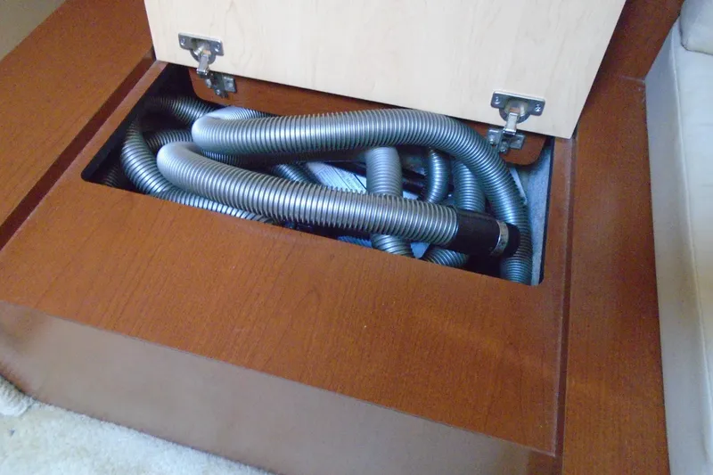 Slide: The Image of Storage compartment with coiled hoses in a 2007 Sea Ray 40 Sundancer boat. - 29