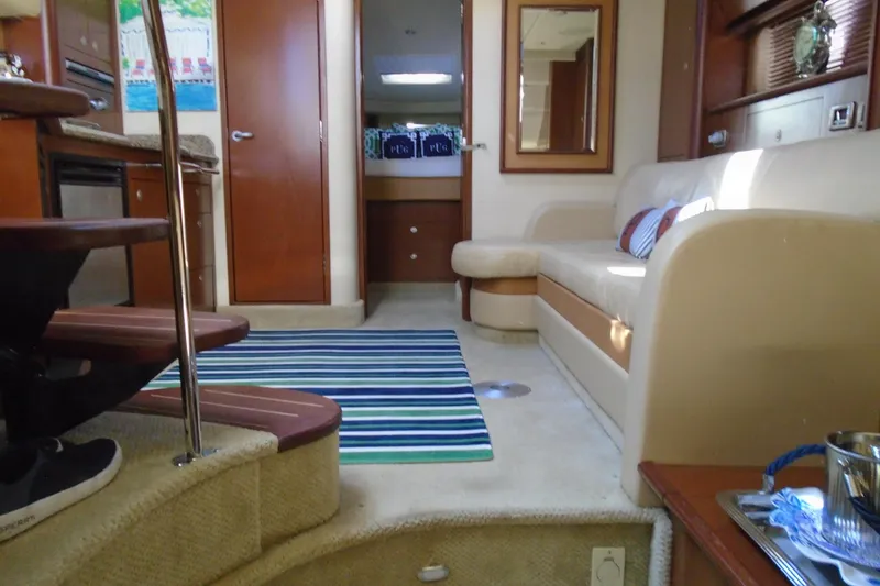 Slide: The Image of Interior of 2007 Sea Ray 40 Sundancer yacht with cozy seating and striped rug. - 33