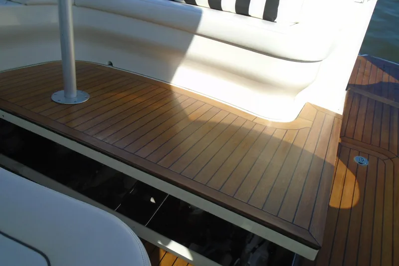 Slide: The Image of 2007 Sea Ray 40 Sundancer boat deck with wooden finish and seating area. - 40