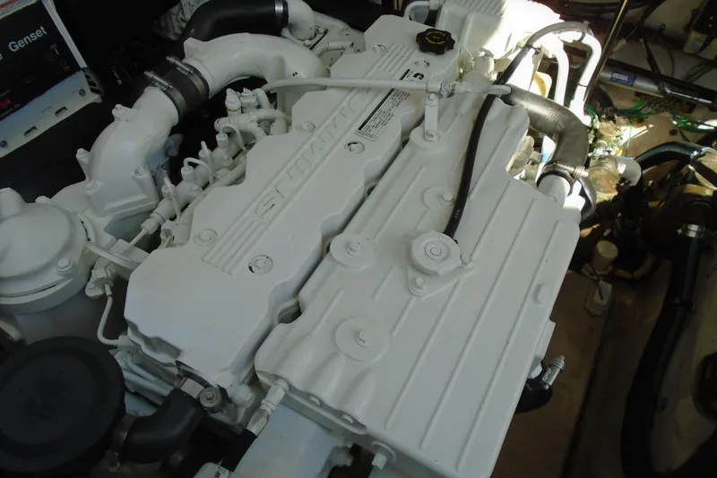 Slide: The Image of Engine compartment of a 2007 Sea Ray 40 Sundancer boat, showcasing a white engine. - 43