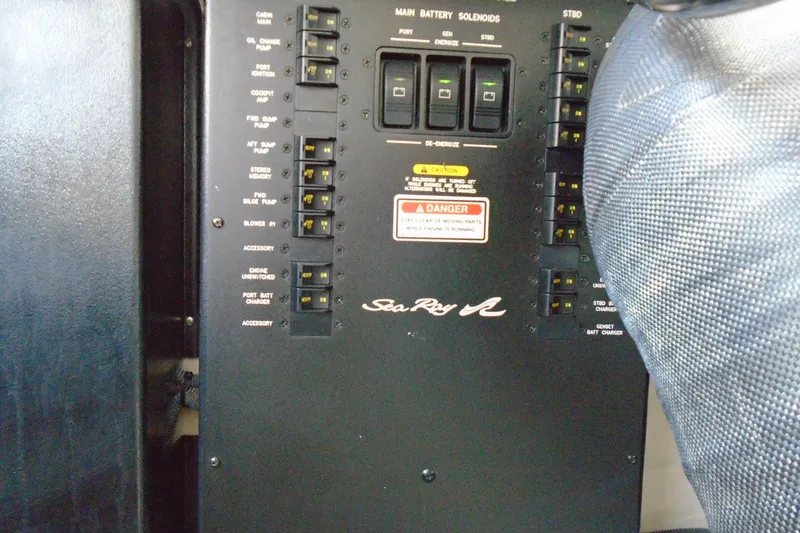 Slide: The Image of Electrical panel of 2007 Sea Ray 40 Sundancer boat with switches and caution labels. - 46