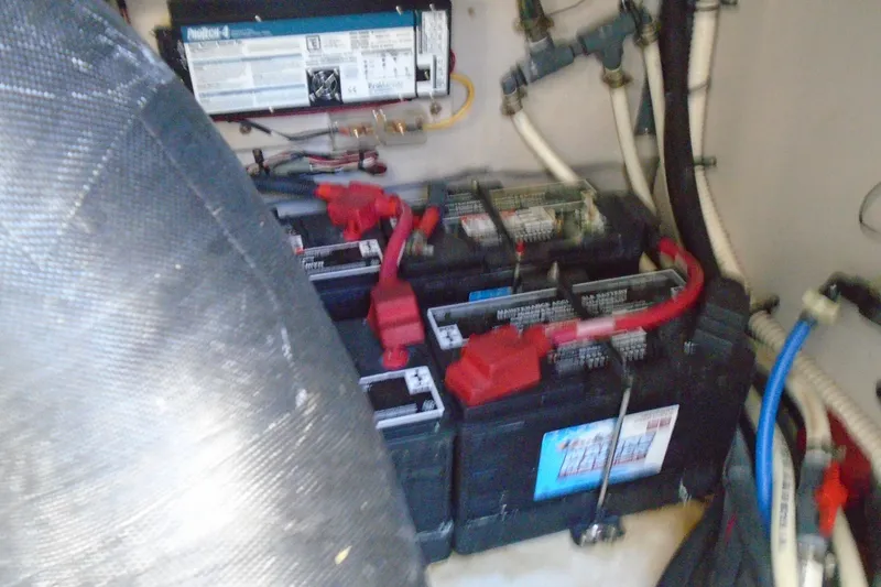 Slide: The Image of Battery compartment of a 2007 Sea Ray 40 Sundancer boat, showing multiple batteries and wiring. - 48