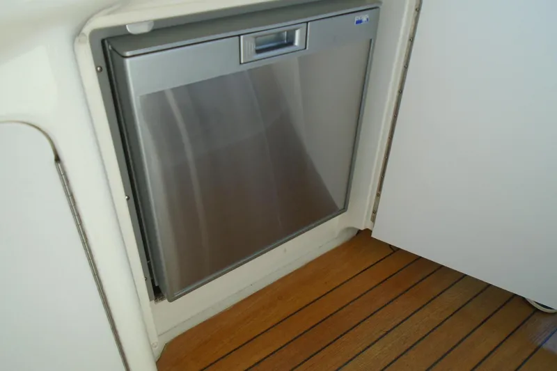 Slide: The Image of Stainless steel refrigerator on 2007 Sea Ray 40 Sundancer yacht, wooden floor visible. - 49
