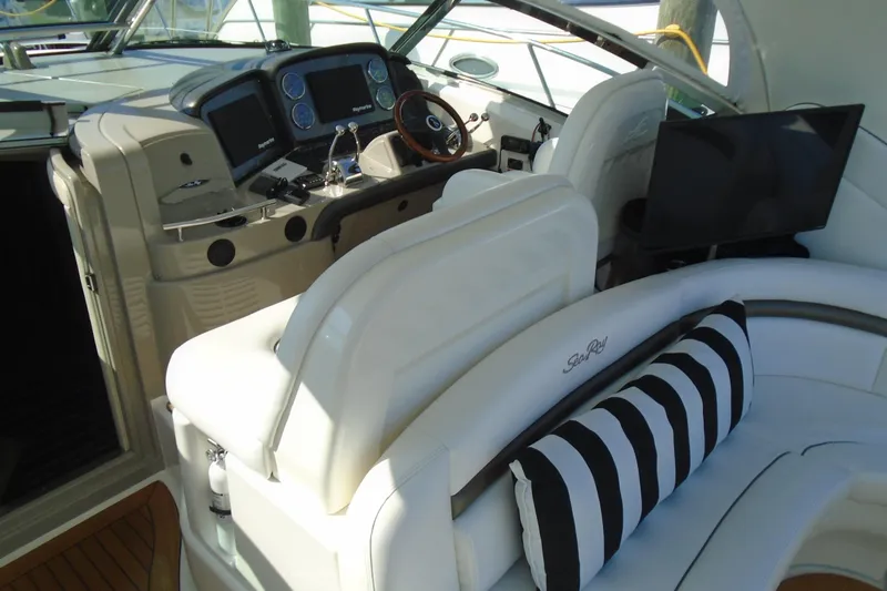 Slide: The Image of 2007 Sea Ray 40 Sundancer cockpit with plush seating and modern controls. - 5