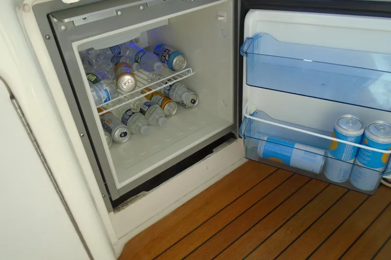 Slide: The Image of Open fridge on 2007 Sea Ray 40 Sundancer, stocked with drinks on wooden deck. - 50