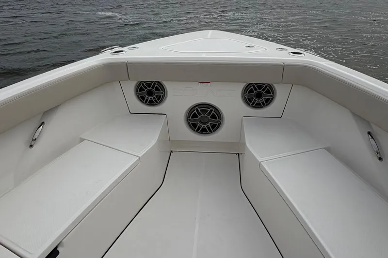 Slide: The Image of Bow seating area of 2026 Solace 37 CS boat with speakers and ocean view. - 10