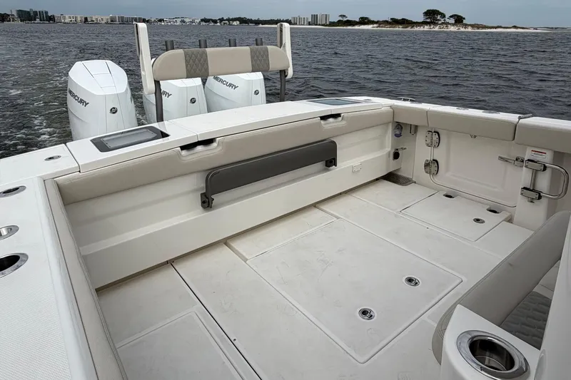 Slide: The Image of 2026 Solace 37 CS boat interior with Mercury engines, spacious deck, and coastal view. - 14