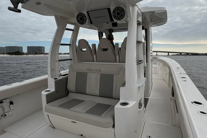 Slide: The Image of 2026 Solace 37 CS boat interior with seating, on open water near a bridge. - 15