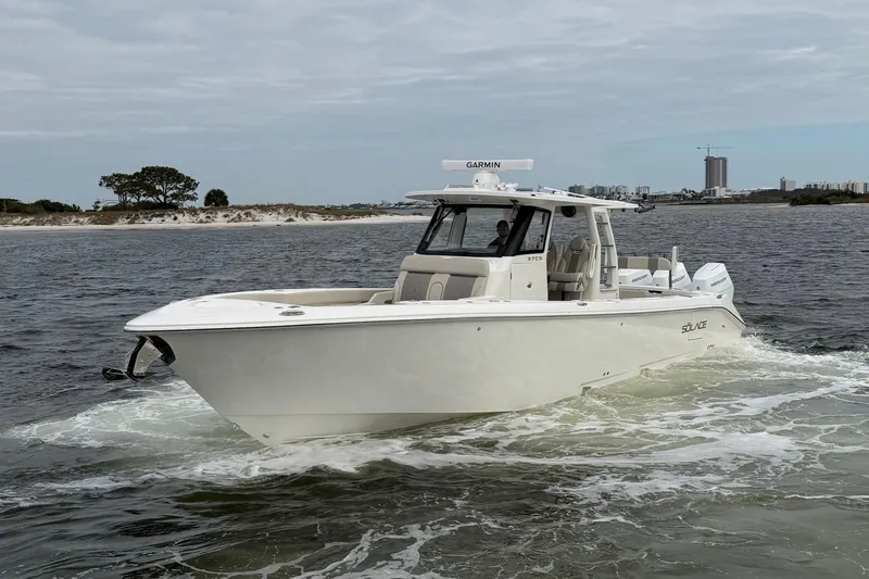 Slide: The Image of 2026 Solace 37 CS boat cruising on open water with coastal background. - 4