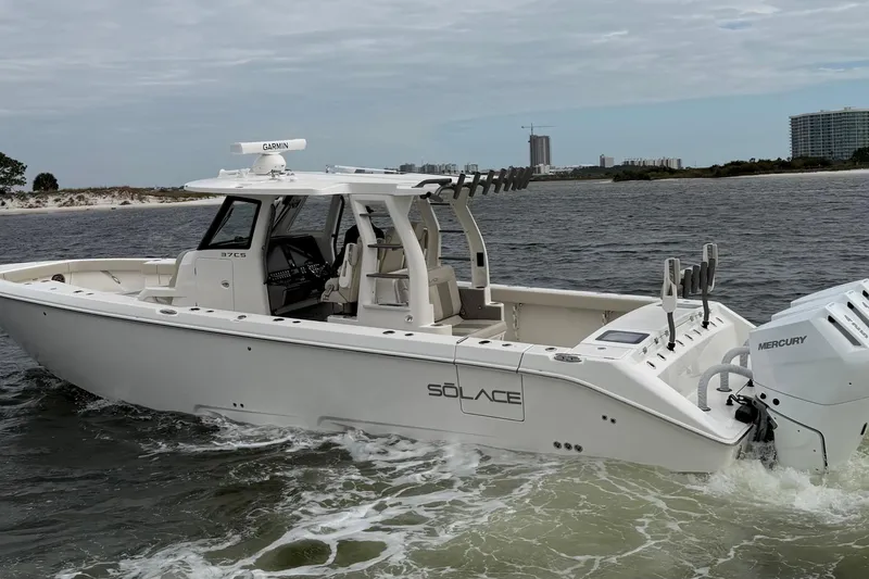 Slide: The Image of 2026 Solace 37 CS boat cruising on water with Mercury engines. - 7