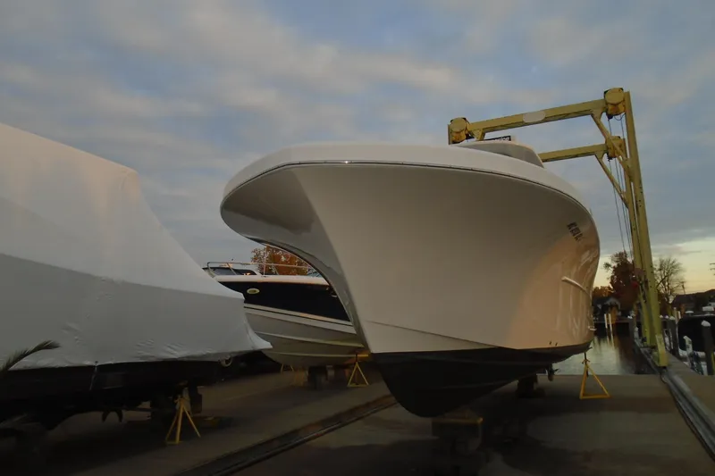 Slide: The Image of 2006 Buddy Davis 34 Center Console boat on a lift at a marina. - 10