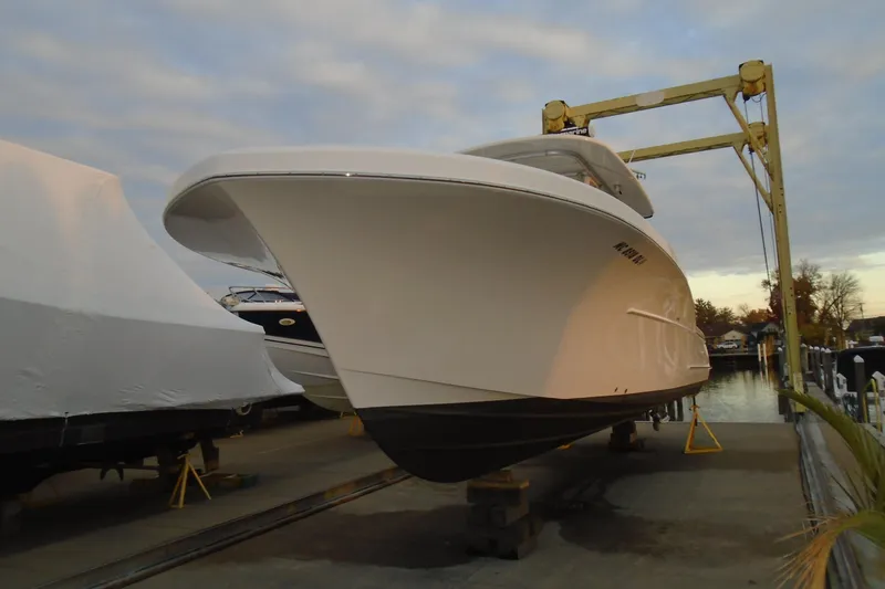 Slide: The Image of 2006 Buddy Davis 34 Center Console boat on a lift at a marina. - 11