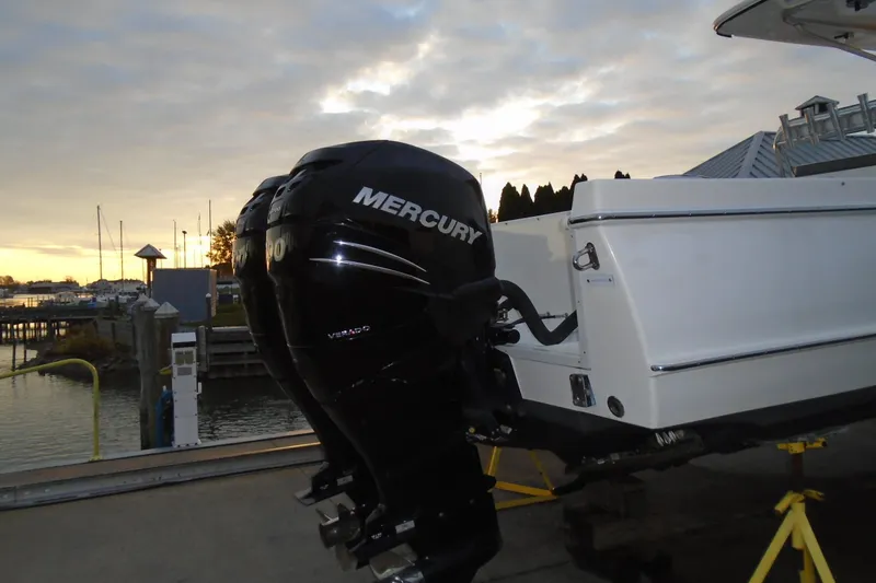 Slide: The Image of 2006 Buddy Davis 34 Center Console with Mercury outboard engine at sunset dock. - 15