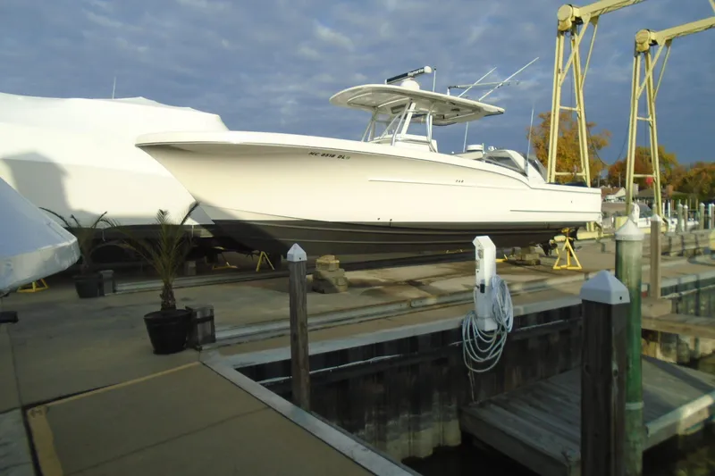 Slide: The Image of 2006 Buddy Davis 34 Center Console boat docked at marina under cloudy sky. - 17